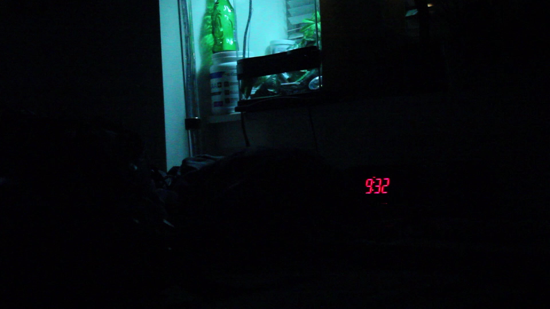 dark room with clock showing time